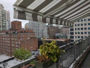 Retractable awning on balcony over looking NYC