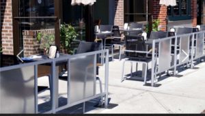 Sidewalk cafe barriers outside restaurant patio