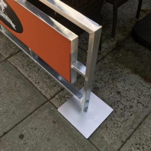 close up view of metal frame on sidewalk cafe barriers for restaurant