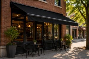 Sidewalk cafe with black awning and chairs